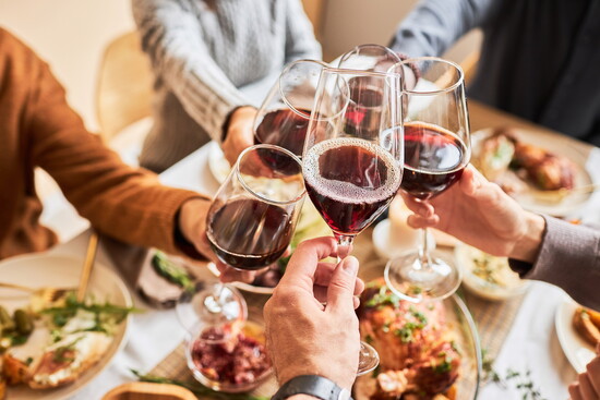 Toasting with red wine at a festive meal.