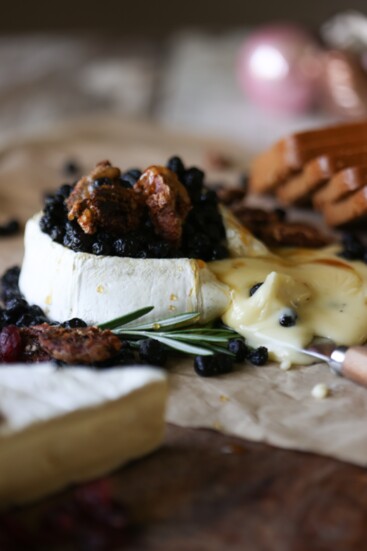 Double creme brie board with with local honey, berries and candied pecans