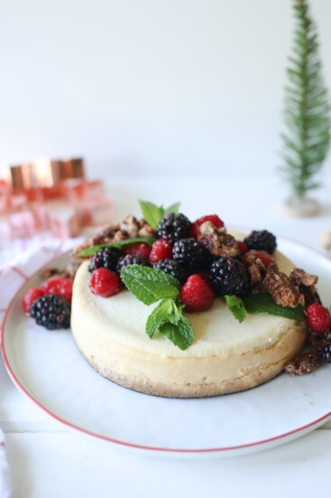 New York Cheesecake with fresh berries and mint sprigs