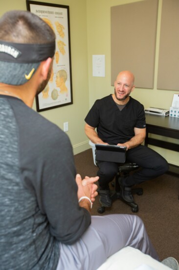 Jon Watkins confers on his treatment with founder and acupuncturist, Ryan Diener