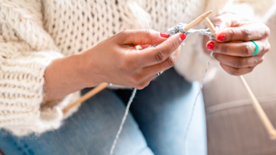 Knitting a sweater while wearing a sweater.