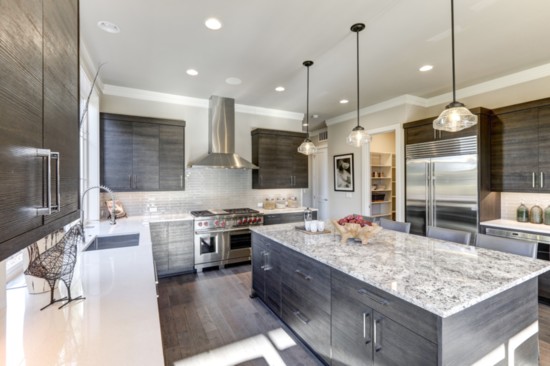 This kitchen sports white subway tile and quartz countertops.