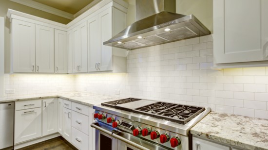 This kitchen is sleek with its white subway tile backsplash.