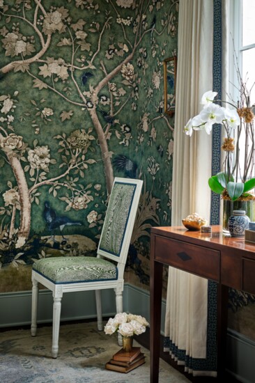 Phillips Scott dining chair accents the dining room, where walls are covered in Schumacher’s Les Oiseaux. The wooden console was Brantley Templeton's parents.