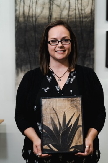 Encaustic artist Shauna Martin with one of her paintings