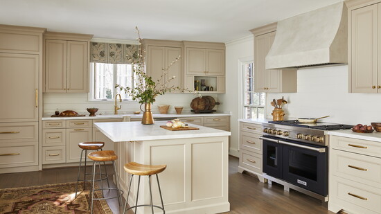 KITCHEN: Cabinetry in Farrow & Ball's Jitney; plaster hood; unlacquered brass fixtures; Ann Sacks marble countertops.