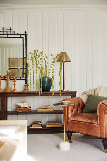 An antique English mirror, bought in Dublin on the homeowners' honeymoon 35 years ago, hangs above a vintage Ralph Lauren leather chair. "We were sure it was