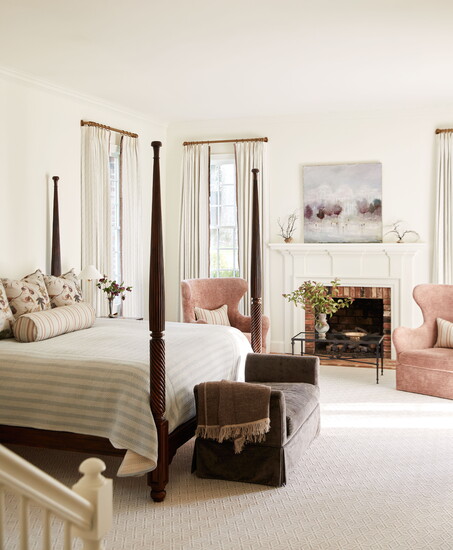 Airy House of Harris fabrics set the tone in the primary suite, where rose-velvet wingbacks and a France Jodoin painting from Shain Gallery add softness and