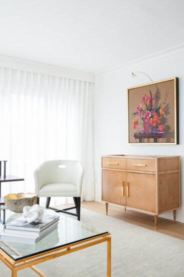 Colorful art by Mary Simms provides a contrast to neutral furnishings