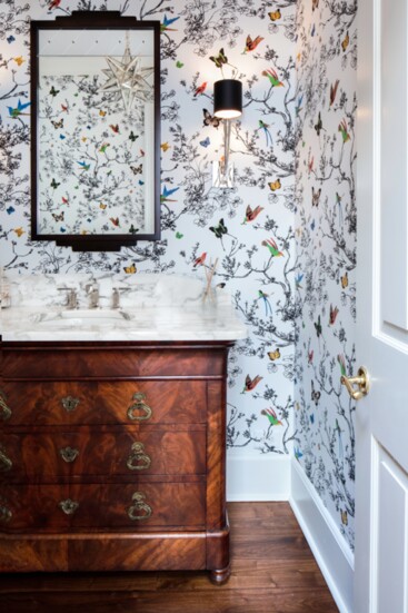 Playful wallpaper adds interest and color to this powder room.