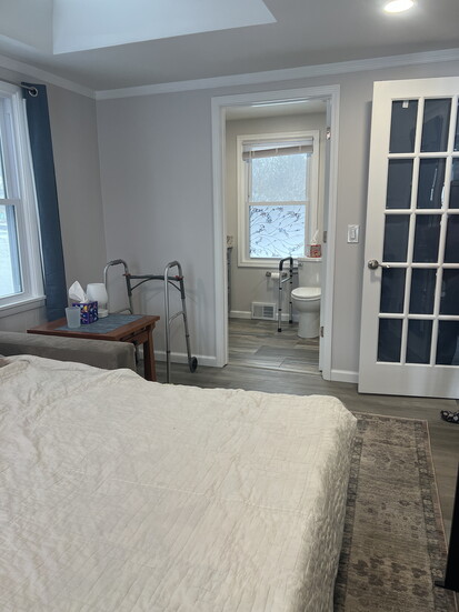 A bonus room transformed into a first-floor bedroom with a bathroom