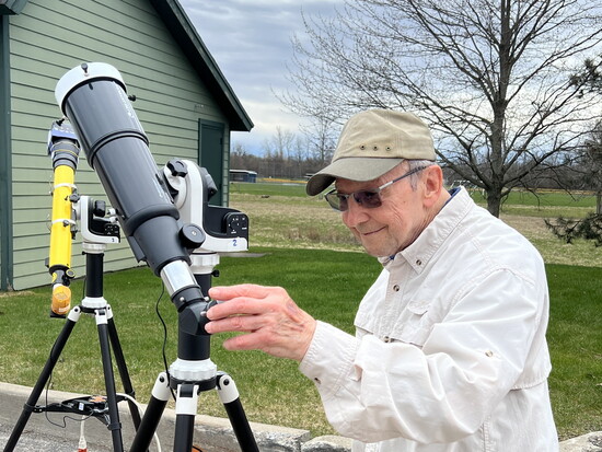 A member of The Summit astronomy club with a solar telescope