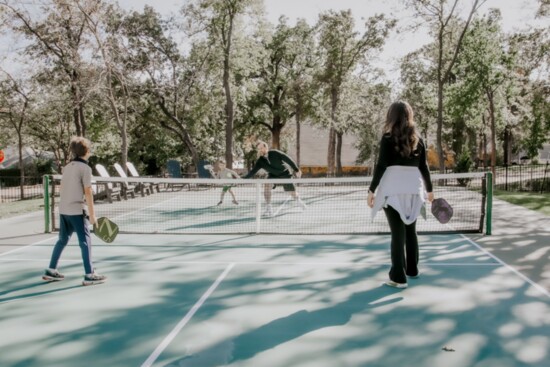The Gustafson family enjoys playing on the pickleball court installed by Randalph Design + Build as part of their home remodel. (Photo Dennise Toews, Studio|D)