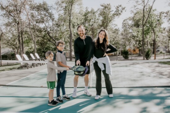 Katy and Brody Gustafson with their sons Park and Guy enjoy time on their new pickleball court. (Photo by Dennise Toews @studiodokc)