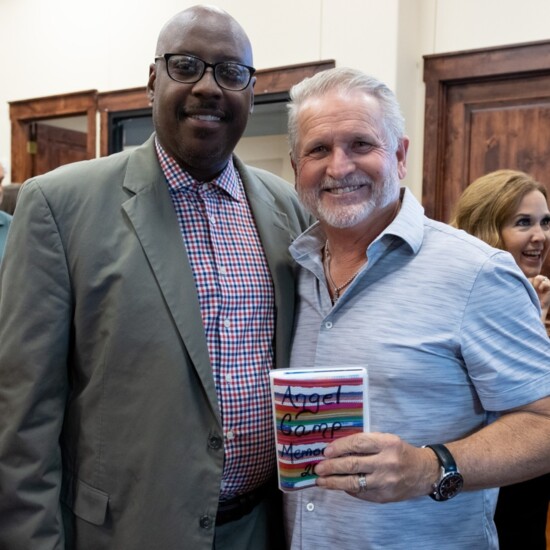 Harold Young, Executive Director Rockwall YMCA giving Mark Andrews, Chairman of the Board, HBTX photo album Angel Camp