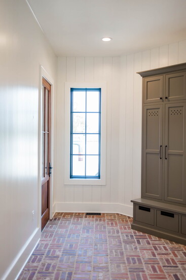 Storage, seating, and durable material, all designed to handle life’s daily rhythm. The brick basketweave floor adds charm and practicality in equal measure.
