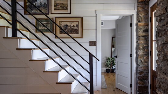 From shiplap walls to original stonework, this entryway tells a layered story. Thoughtful transitions and curated art make even pass-through spaces memorable.