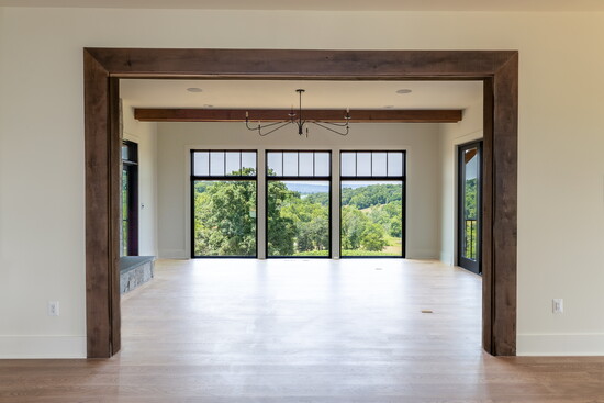 Clean lines and natural materials direct your eye outward, emphasizing indoor-outdoor living. Framed openings like this one create visual rhythm.