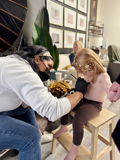 Piper getting her chest scar painted by Suha