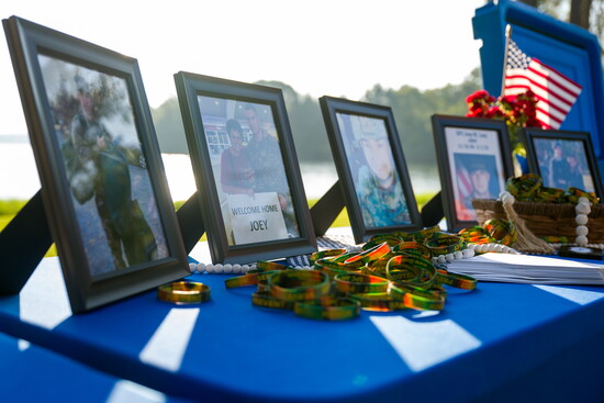 Memorial table with photos and medals honoring Specialist Joey Lenz at the ceremony.