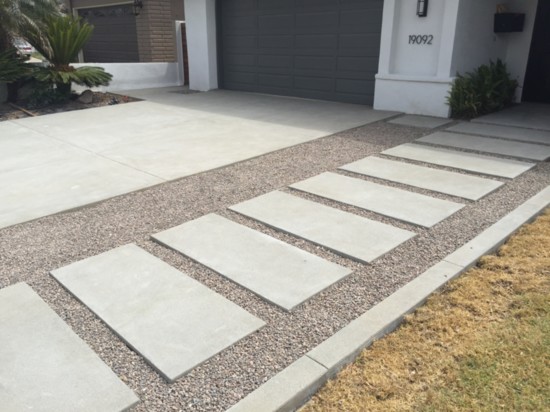 Beautiful driveway with crushed pebble entrance walkway.