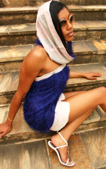 This luxurious, blue cashmere mini-dress is paired with a delicate pastel chiffon hijab, blending transition and modern fashion.