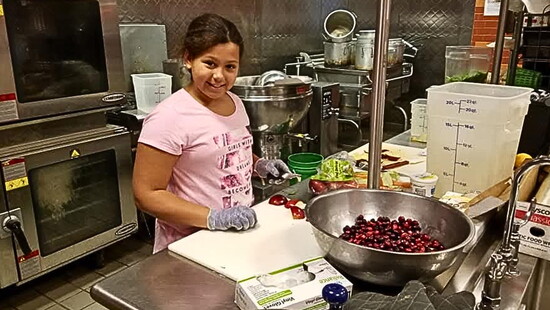 Patrick Rae's daughter, Isabelle, helping cook Thanksgiving at FLCC