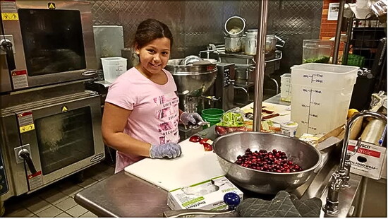 Patrick Rae's daughter, Isabelle, helping cook Thanksgiving at FLCC