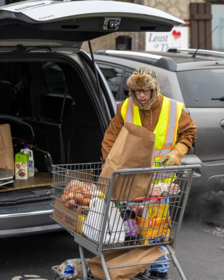 Volunteers load the food supplies into client's vehicles.