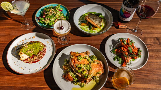 A spread of Burl’s seasonal dishes and cocktails, showcasing the Evanston restaurant’s produce‑driven menu and craft beverage program. (Photo by Kinship)