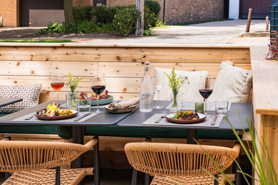 Outdoor dining at Burl in Evanston, set with seasonal plates, wine and the restaurant’s signature warm hospitality. (Photo courtesy of Kinship)