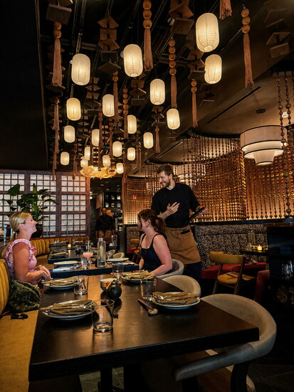 A warm, lantern‑lit moment inside Zenzi Den, capturing the restaurant’s intimate atmosphere and design details in Glenview. (Photo by Cat Rolfes)
