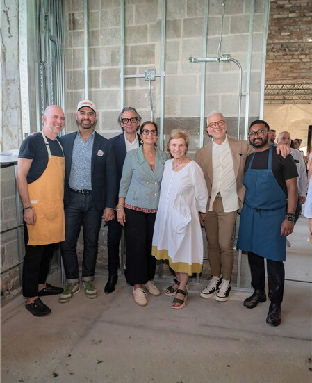 The avec Highwood team gathers inside the in‑progress space during the restaurant’s mid‑construction preview. (Photo by Widia Viti)