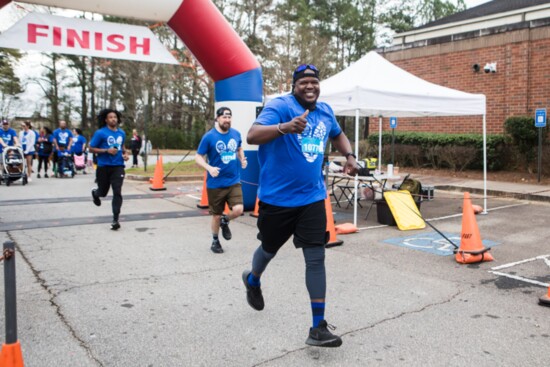Runners cross the finish line.