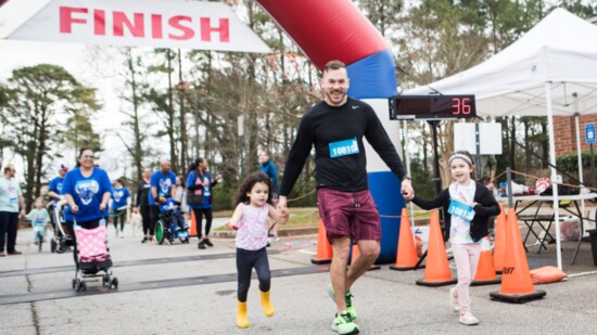 Runners reach the finish line at Hustle for Hope.