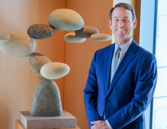 Hyatt's son Powell Brown, President & CEO of Brown & Brown with a sculpture by Woods Davy. (Photo Credit: Brown & Brown)