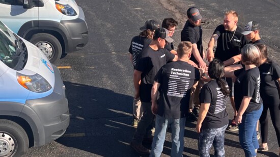 Joe Turner and the Restoration 1 team huddle before launching their workday.