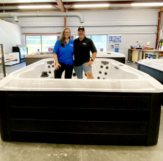 Alyson and Larry "The Pool Guy" Otto stand in one of their beautiful, Generation hot tubs in the store. Photo provided.