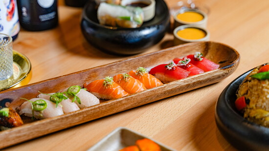 "The wooden backdrop allows each nigiri piece’s vibrant colors to stand out while creating a dramatic moment when it arrives table-side due to its size."