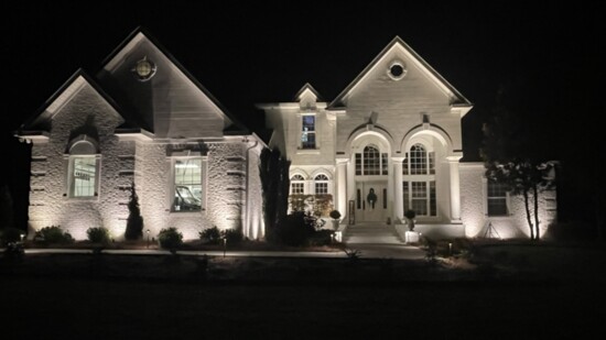 The beautiful architecture of this home is accentuated by well-placed outdoor lighting. 