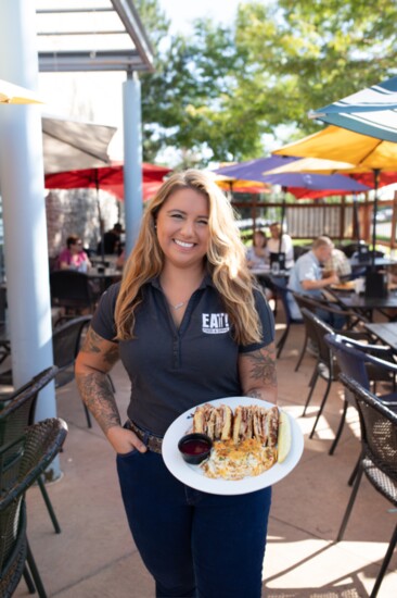 General Manager Brittany Bartlett showing off a popular menu item, the Huckleberry Monte Cristo 