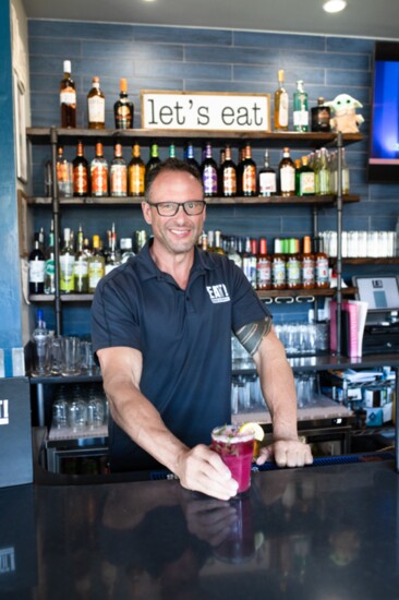 Owner David Frieder flaunting his most popular cocktail creation, the Huckleberry Smash