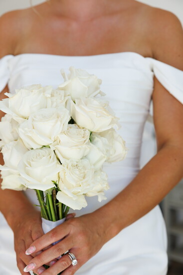 Kaitlyn Sherfy holding a bouquet provided by Xquisite Floral.
