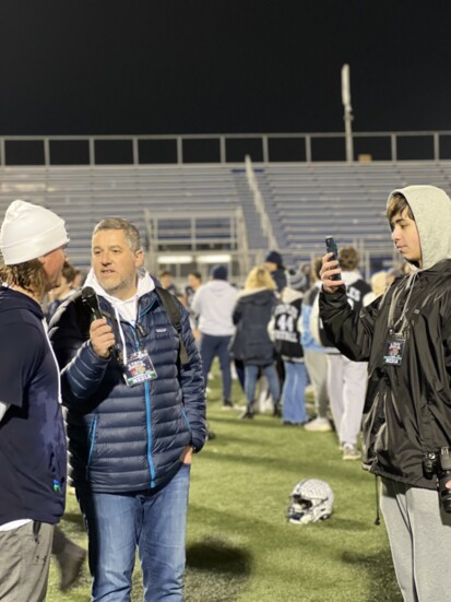 Estevao conducting an on-the-field post-game interview. 