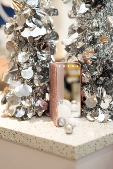 Phone charger and lighted magnifying mirror decorated with Swarovski® crystals.