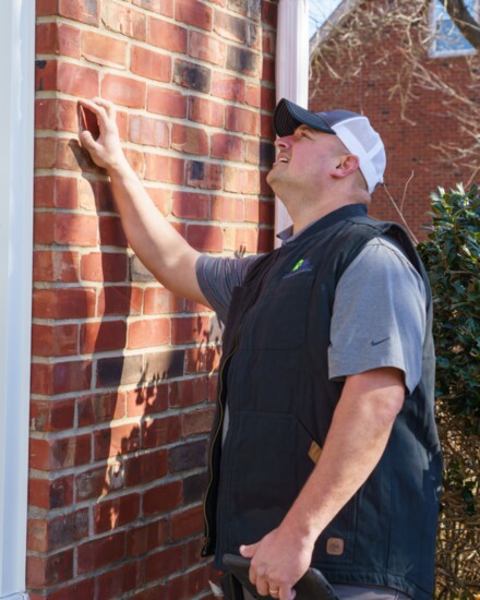 Mike Daggett inspects a window seal.