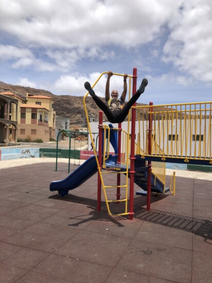 Eddie Estevez does a few pull-ups on a playground his group built in Cabo Verde.