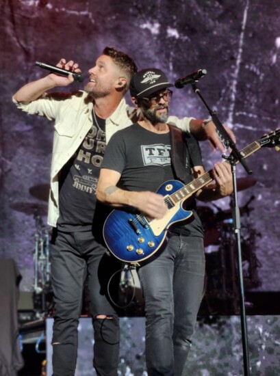 Tony Lucca on stage and on guitar with Brett Young.