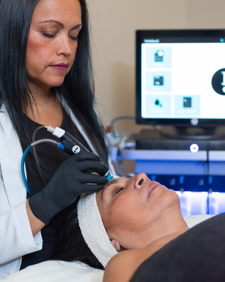 Tania performing a cavitation treatment for a client
