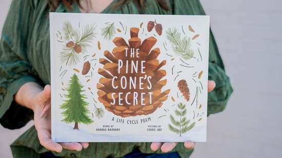Hannah Barnaby with her book, "The Pine Cone's Secret." Photo Credit: Beth Kagarise